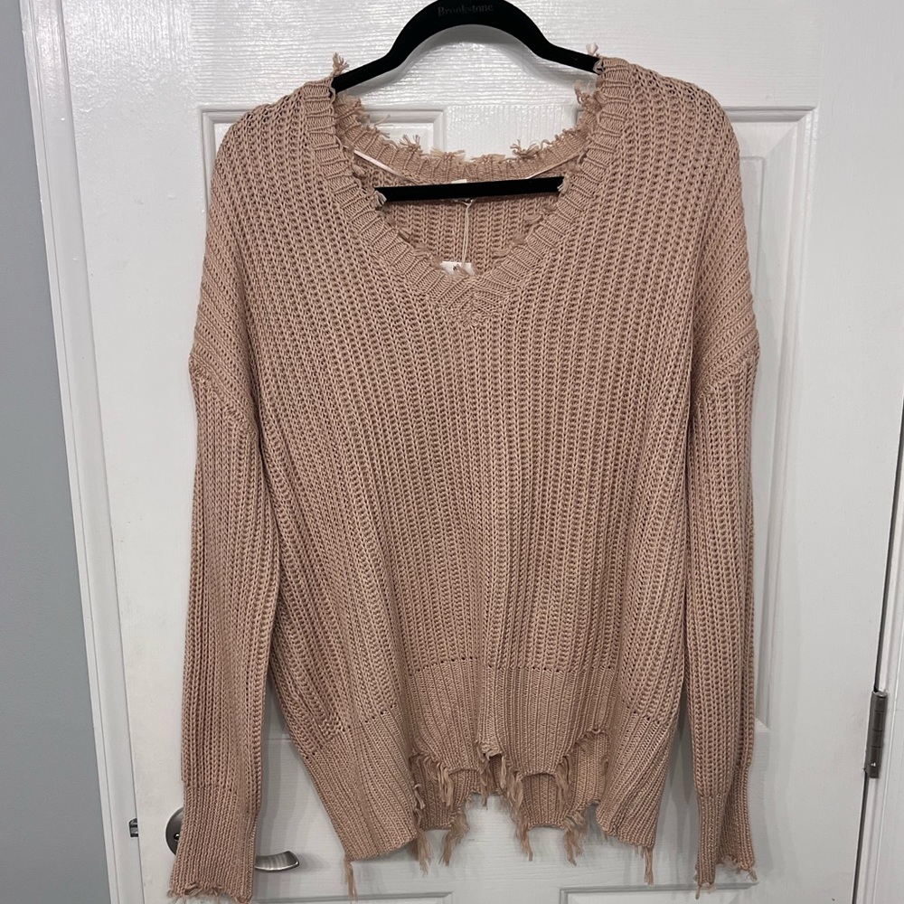 Hem and thread distressed sweater